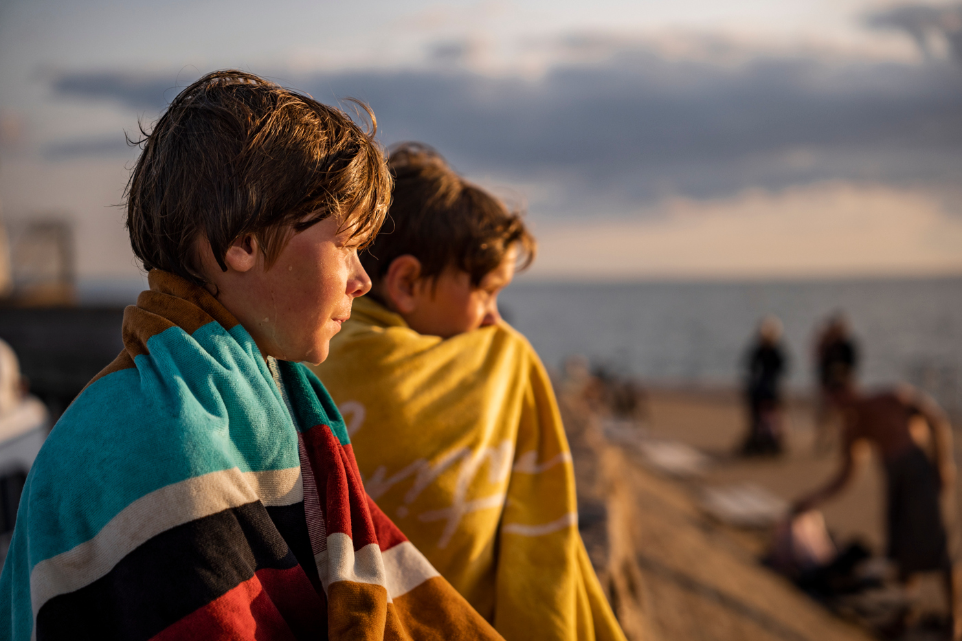 two boys with bath towels around their backs