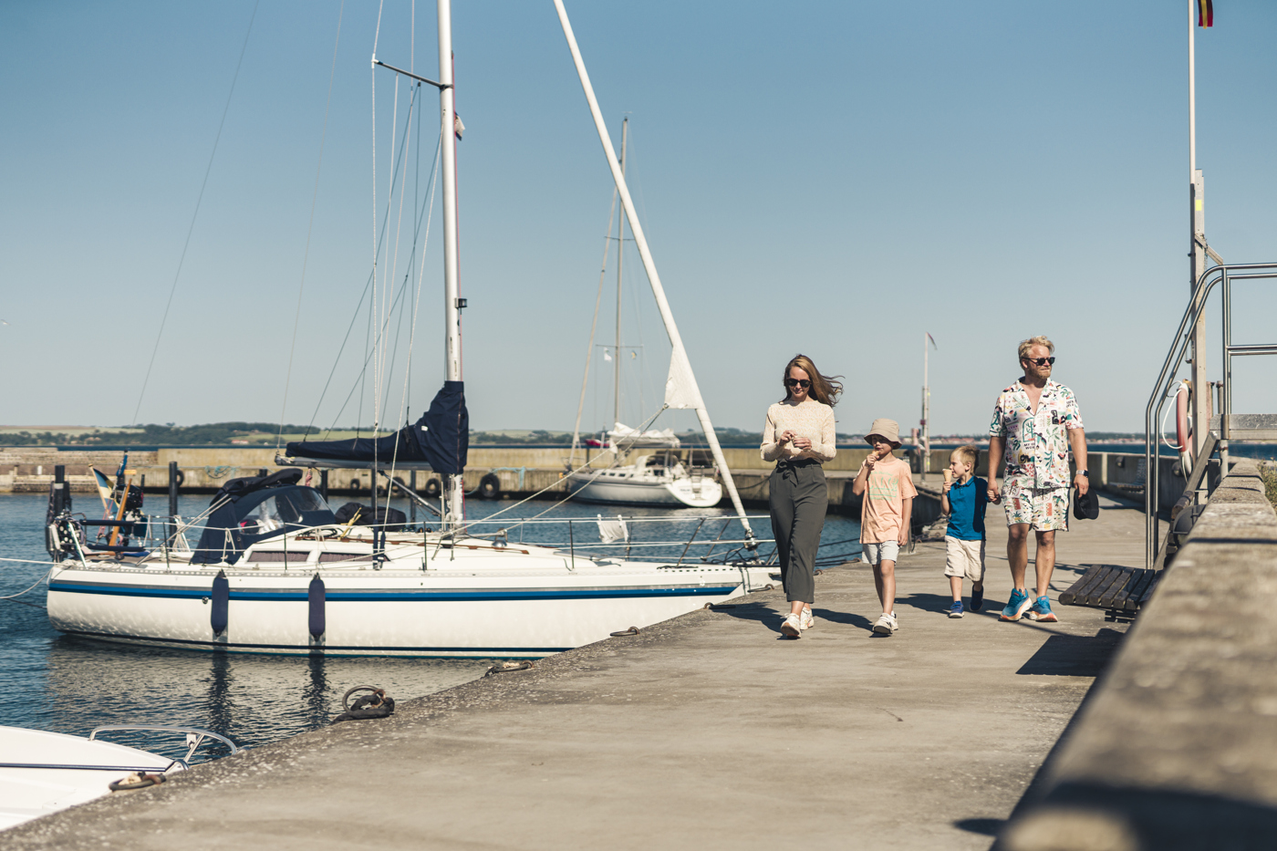 A family are walking in Bäckviken harbour